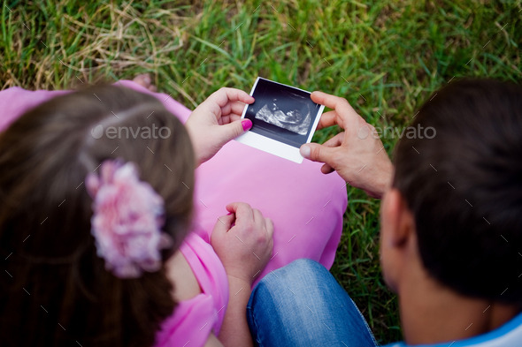 Prospective parents looking at ultrasound scan (Misc) Photo Download