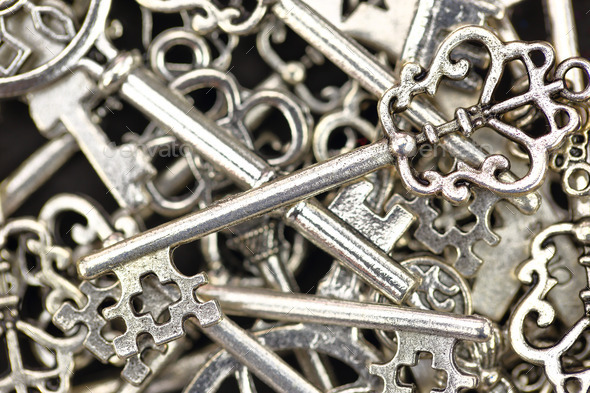 Pile of antique metallic keys closeup background