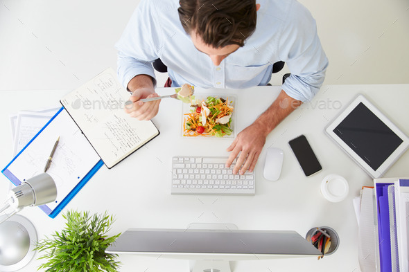 Overhead View Of Businessman Working At Computer In Office
