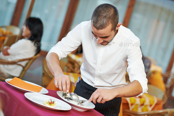 waiter man dressing fish at restaurant (Misc) Photo Download