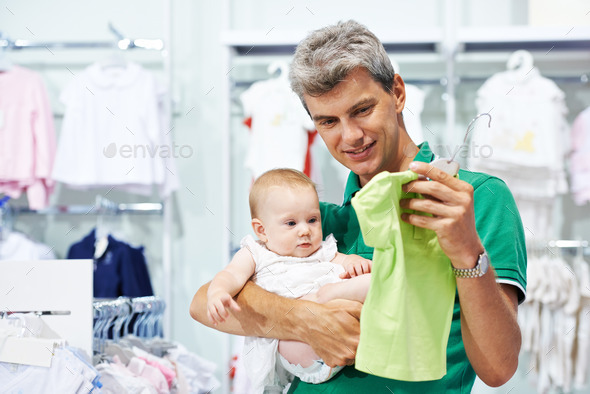 man and baby shopping clothes