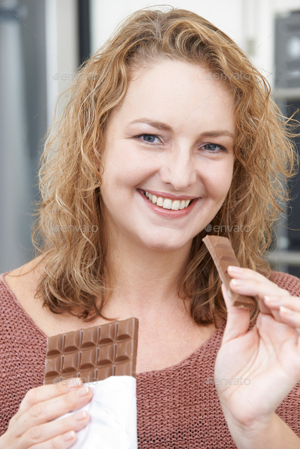 Smiling Plus Size Woman Eating Bar Of Chocolate