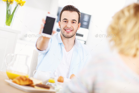 Happy man showing smart phone (Misc) Photo Download