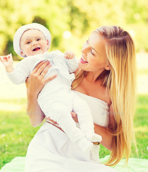 happy mother with little baby sitting on blanket (Misc) Photo Download