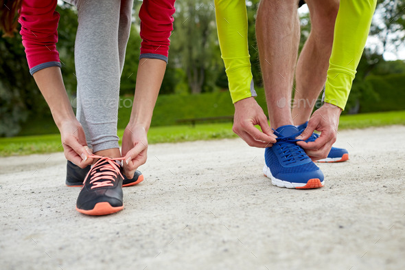 close up of couple tying shoelaces outdoors (Misc) Photo Download