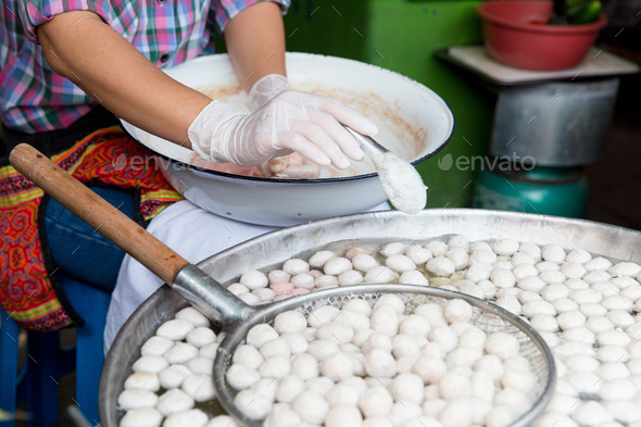 close up of cook frying meatballs at street market (Misc) Photo Download