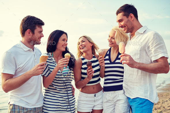 friends eating ice cream and talking on beach (Misc) Photo Download