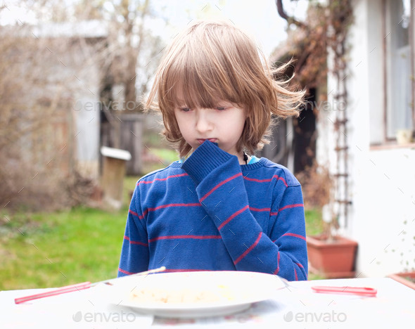 Boy with Blond Hair Eating Outdoors
