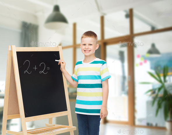 happy little boy with blackboard and chalk