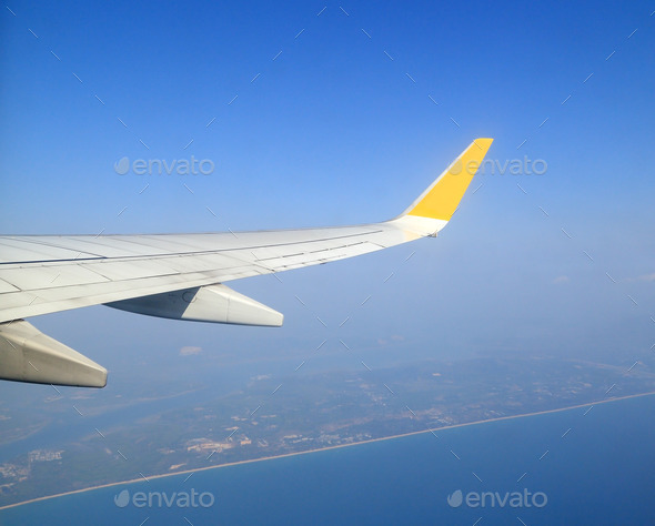 Wing of an airplane flying above sky (Misc) Photo Download