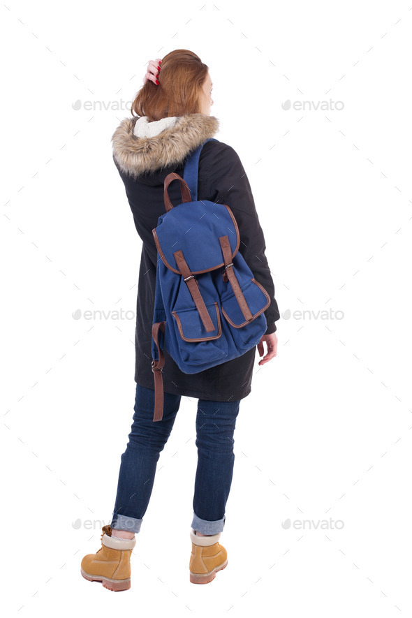 Back view woman in winter jacket with a backpack looking up (Misc) Photo Download