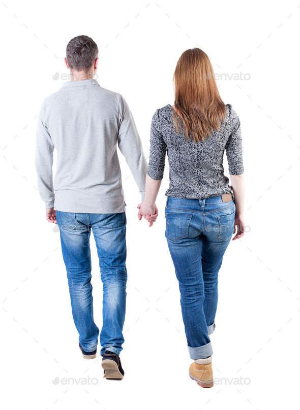 Back view going couple. walking friendly girl and guy holding h (Misc) Photo Download