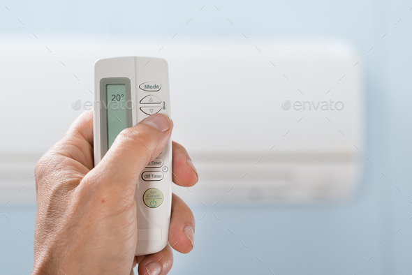 Person Hand Holding Air Conditioner Remote