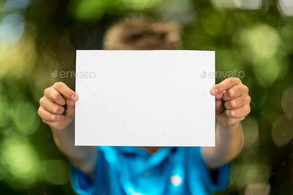 Boy with blank piece of paper