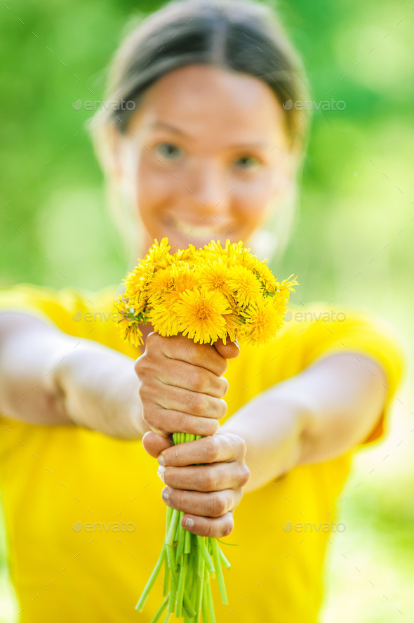 young woman in with bouquet of dandelions