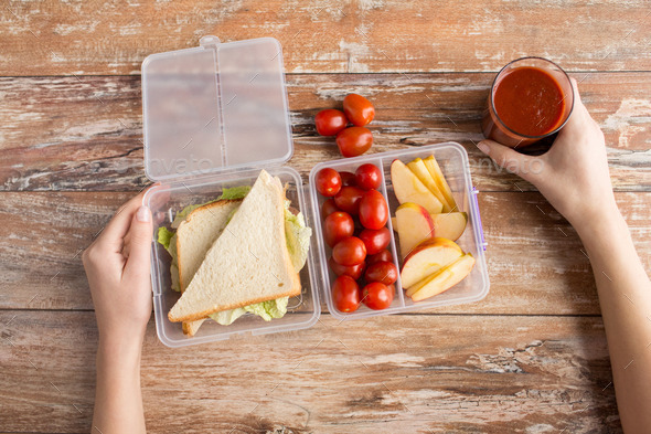 close up of woman with food in plastic container