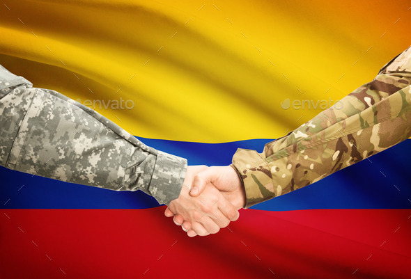 Men in uniform shaking hands with flag on background - Colombia