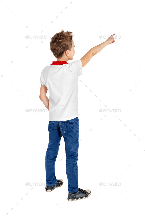 Rear view of a school boy over white background pointing upwards. Full length portrait (Misc) Photo Download