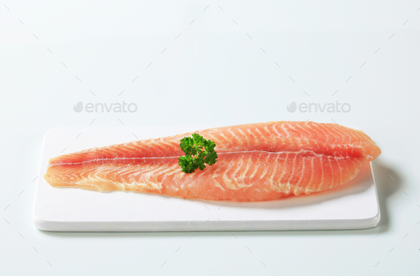 Raw skinless fish fillet on cutting board (Misc) Photo Download