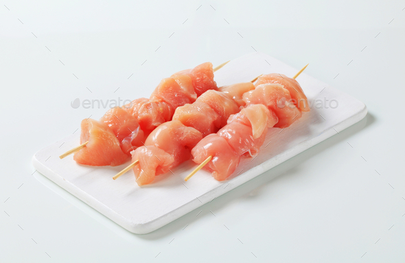 Raw chicken skewers on cutting board (Misc) Photo Download