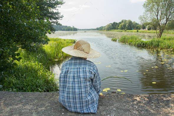 Angling boy with fishing rod on concrete bridge back view (Misc) Photo Download