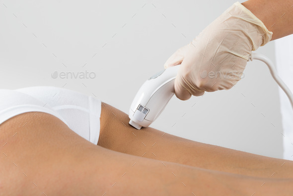 Woman Receiving Laser Treatment On Buttock