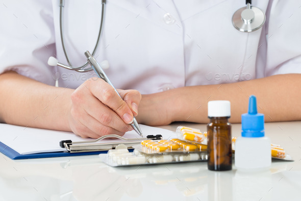 Doctor Writing Prescription On Clipboard (Misc) Photo Download