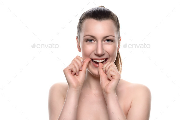 Smiling naked woman using dental floss (Misc) Photo Download