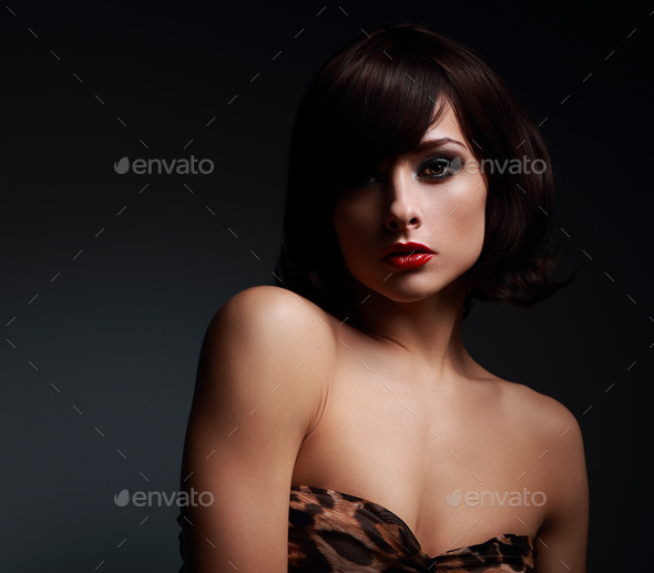 Sexy short hair woman with bright makeup on dark background