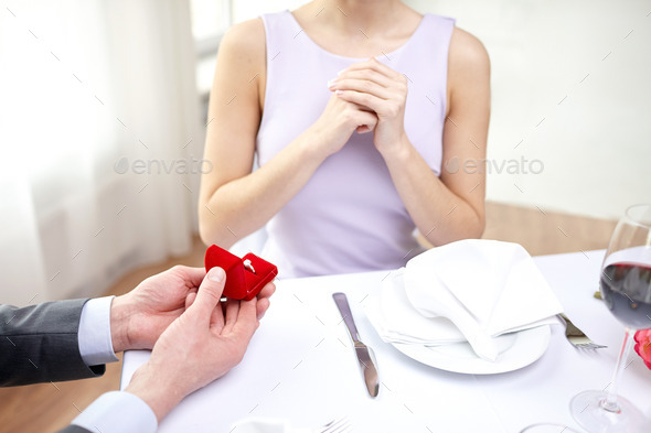 excited young woman and boyfriend giving her ring (Misc) Photo Download