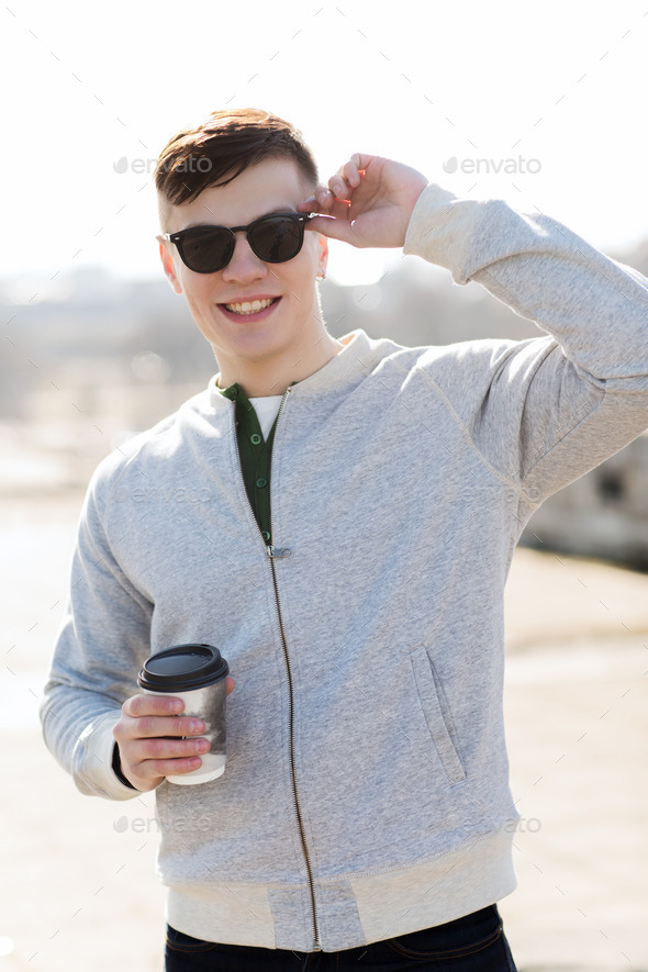 smiling young man or boy drinking coffee (Misc) Photo Download