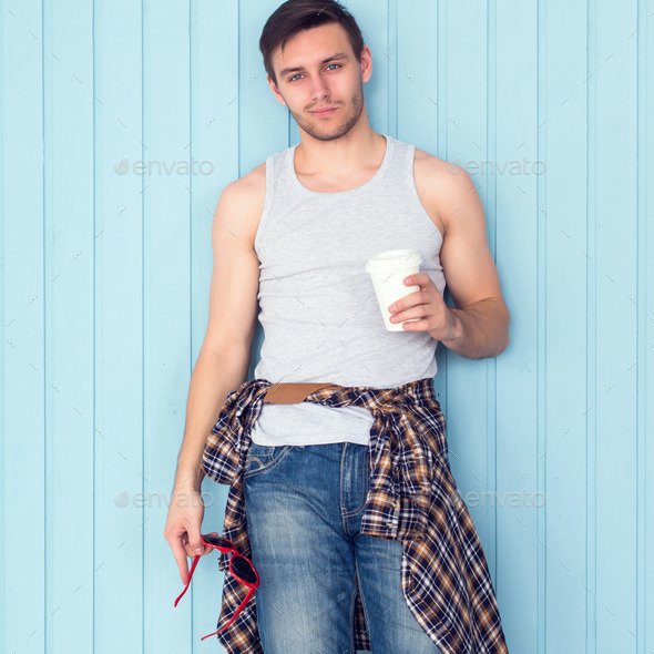 Portrait young man drinking holding paper cup of coffee