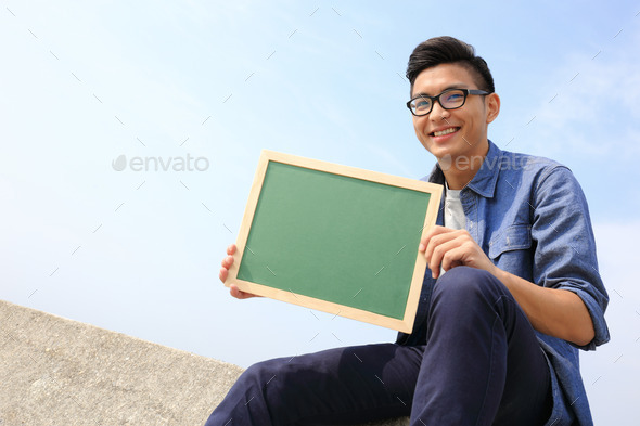 Happy man holding blackboard (Misc) Photo Download