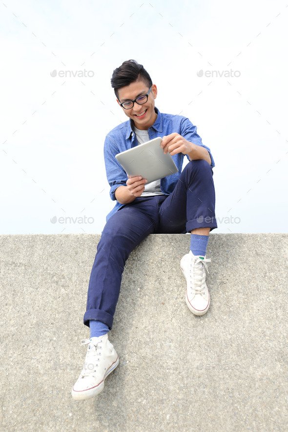 Happy man using digital tablet (Misc) Photo Download