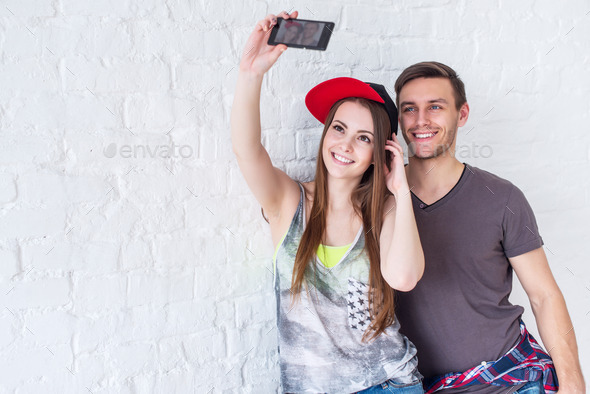 Couple friends taking selfie self-portrait picture photo together with camera