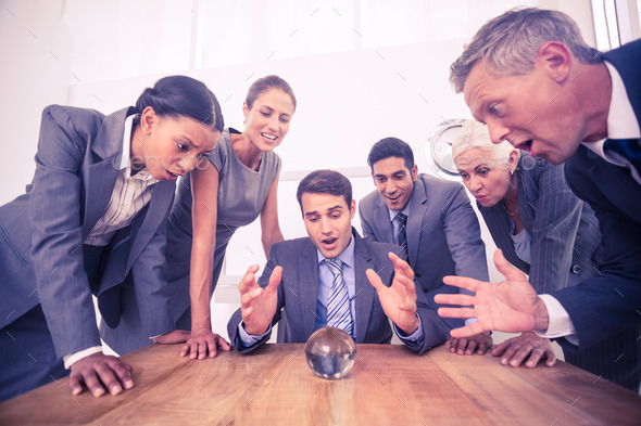 group of business man predict the future with a crystal ball (Misc) Photo Download