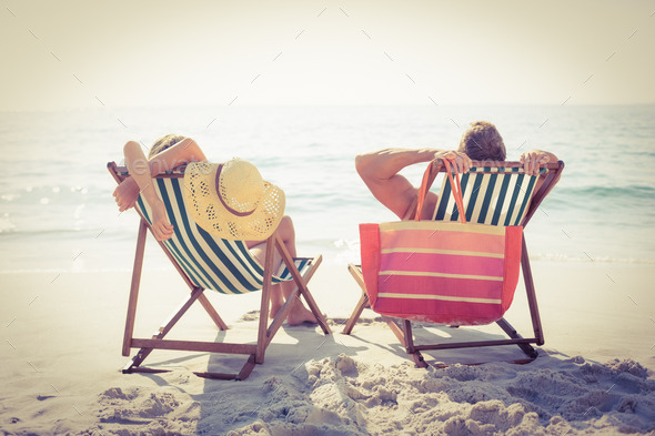 Couple relaxing on the beach on a sunny day