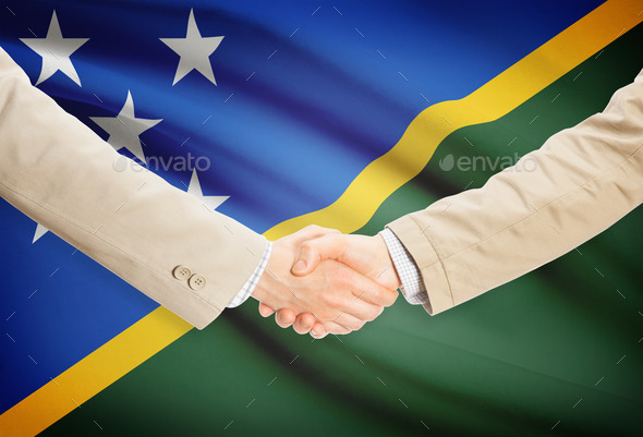 Businessmen handshake with flag on background - Solomon Islands