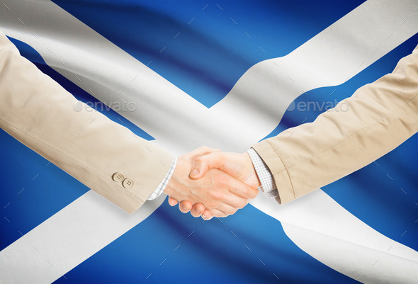 Businessmen handshake with flag on background - Scotland