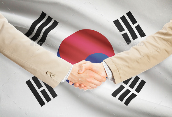 Businessmen handshake with flag on background - South Korea
