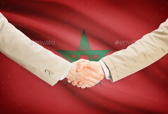Businessmen handshake with flag on background - Morocco