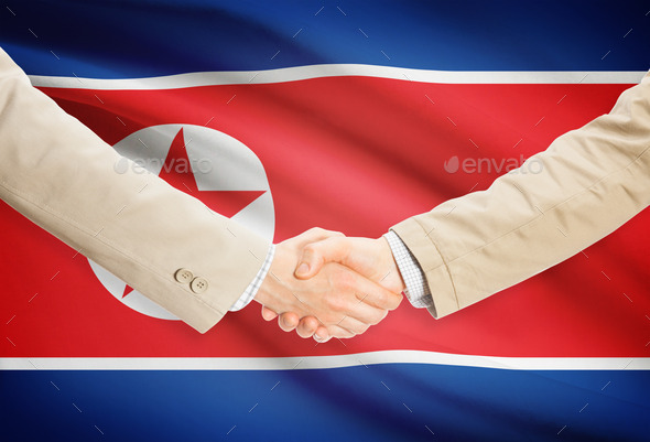 Businessmen handshake with flag on background - North Korea