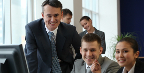 Businessman talking to co-workers Businessman talking to co-workers
