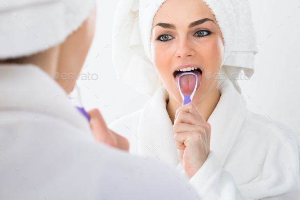 Woman Cleaning Her Tongue
