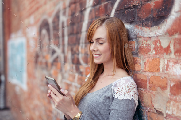 Young woman looking at the screen of her phone