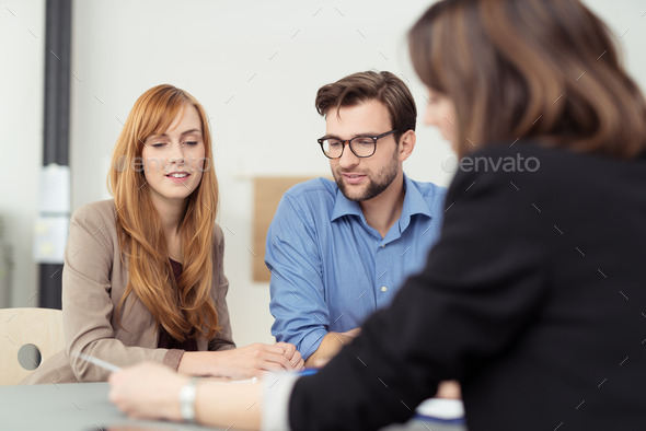 Broker making a presentation to a young couple