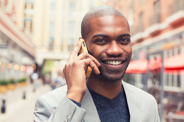 professional smiling man using smart phone talking on mobile