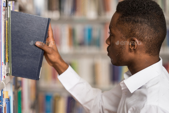 Male College Student In A Library