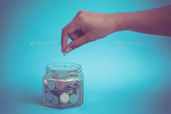 hand putting money coins with filter effect retro vintage style