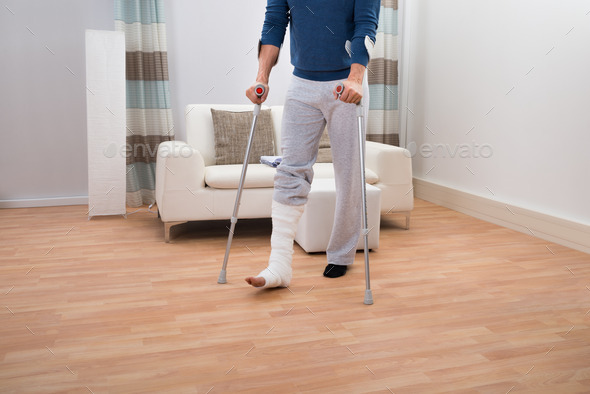 Man Using Crutches For Walking